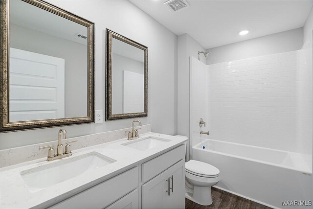 full bathroom featuring vanity, shower / bathing tub combination, wood-type flooring, and toilet