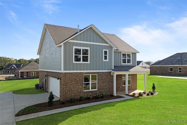 view of front facade featuring central AC unit, a front yard, and a garage