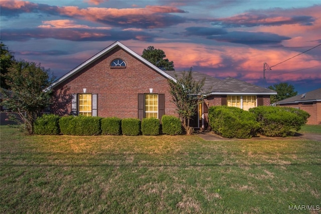 single story home featuring a front lawn and brick siding
