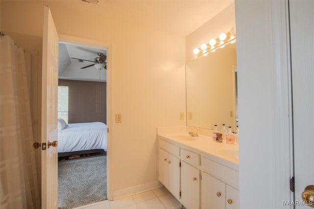 bathroom with tile patterned flooring, vanity, and ceiling fan