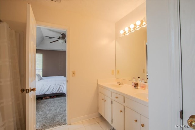 ensuite bathroom featuring double vanity, tile patterned flooring, a ceiling fan, connected bathroom, and a sink