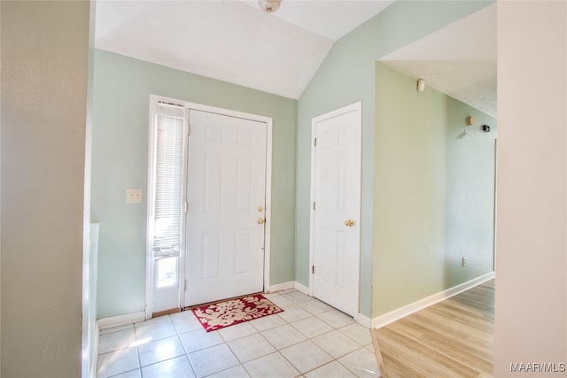 foyer entrance featuring lofted ceiling and light tile patterned floors