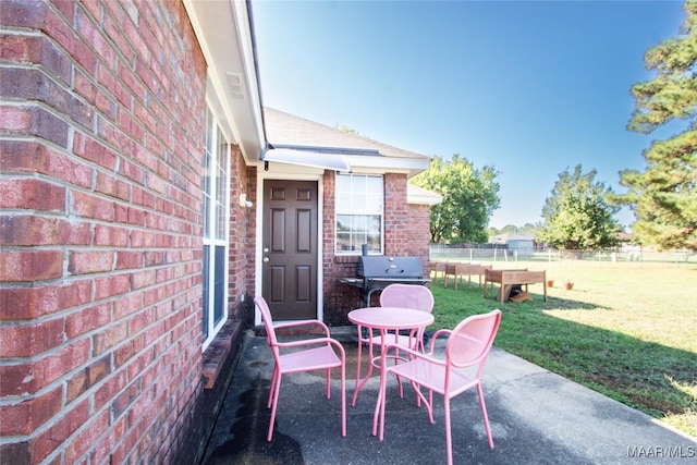 view of patio featuring grilling area and fence