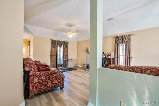 living room featuring hardwood / wood-style floors, ceiling fan, and plenty of natural light