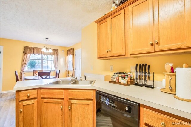 kitchen featuring light wood-type flooring, dishwasher, a textured ceiling, sink, and kitchen peninsula