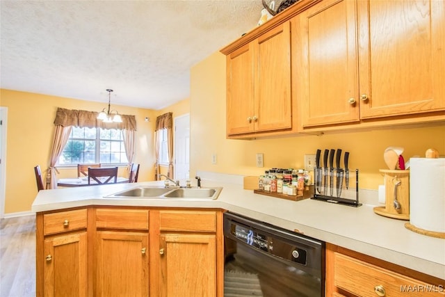 kitchen with a chandelier, a peninsula, light countertops, dishwasher, and a sink