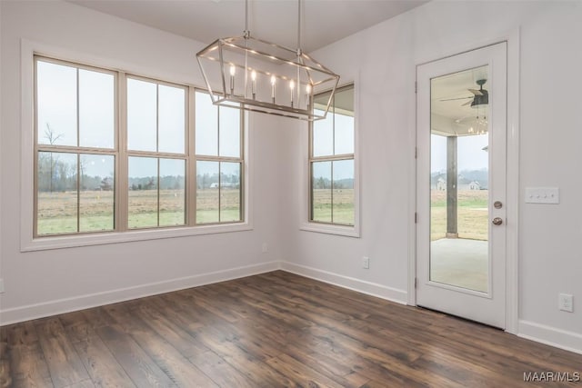 unfurnished dining area featuring dark hardwood / wood-style floors and a notable chandelier