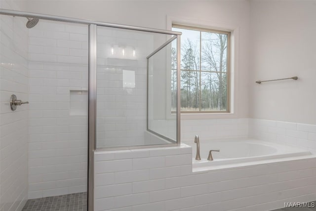 bathroom featuring shower with separate bathtub