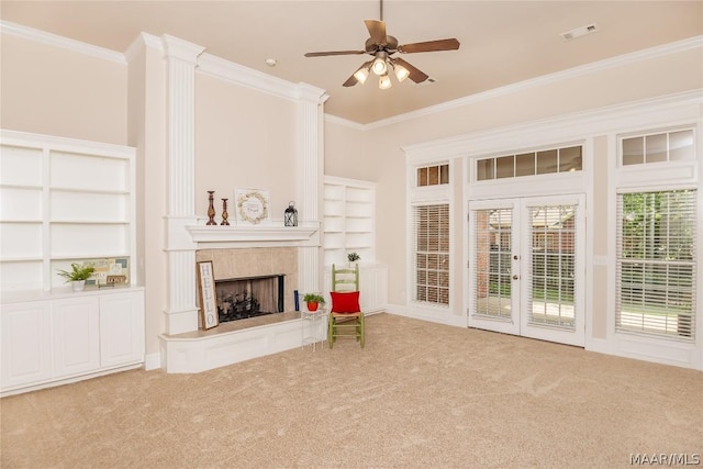 unfurnished living room with crown molding, light carpet, and french doors