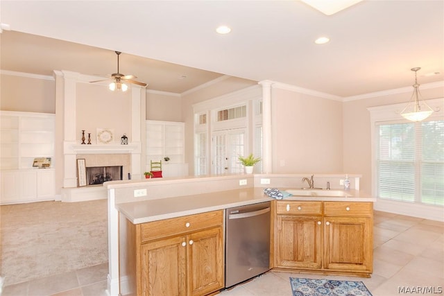 kitchen with light carpet, sink, hanging light fixtures, stainless steel dishwasher, and a fireplace