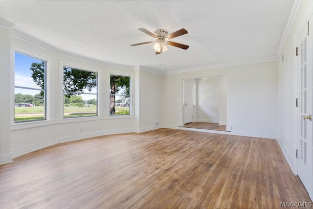 empty room featuring crown molding, ceiling fan, and light wood-type flooring