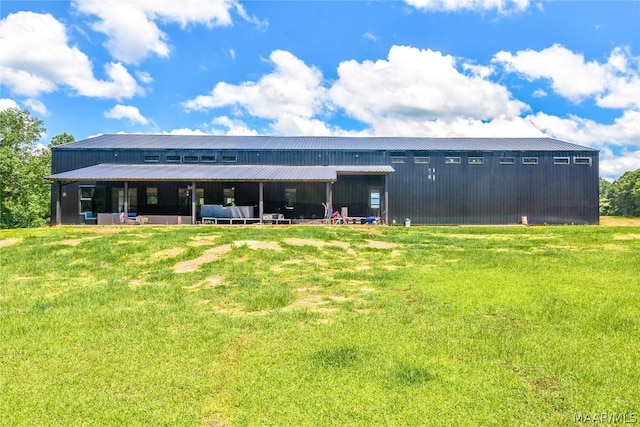 back of house with a lawn