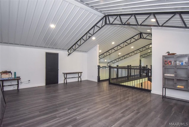 interior space featuring dark hardwood / wood-style flooring and high vaulted ceiling