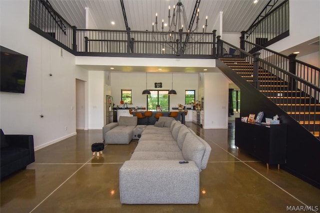 living room with a high ceiling and an inviting chandelier