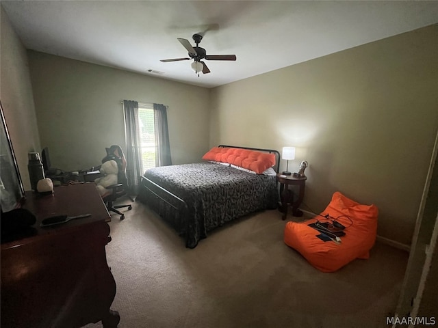 carpeted bedroom with ceiling fan and visible vents