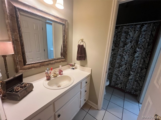 full bath with vanity, toilet, and tile patterned floors