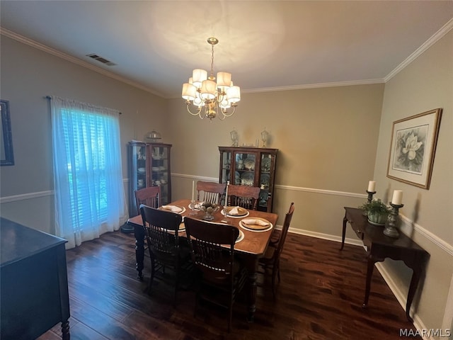 dining room with dark wood-style floors, ornamental molding, a chandelier, and visible vents