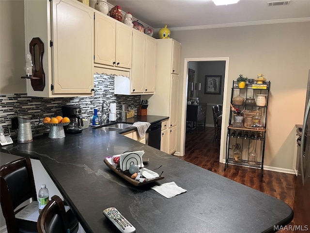 kitchen with dark wood-style floors, crown molding, tasteful backsplash, dark countertops, and visible vents