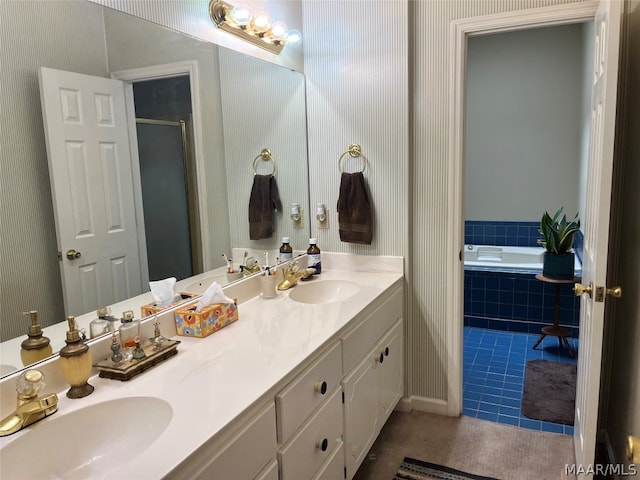 full bathroom featuring a bath, wallpapered walls, a sink, and tile patterned floors