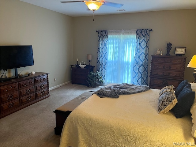 bedroom featuring light carpet, baseboards, visible vents, and a ceiling fan