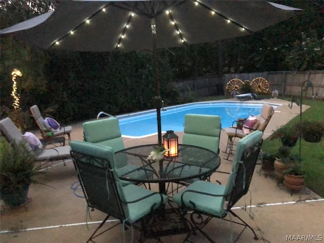 view of pool with a diving board, a patio area, a fenced backyard, and a fenced in pool