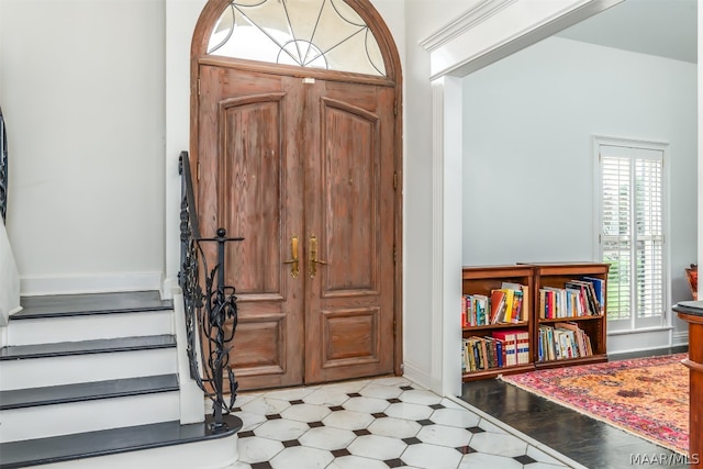 foyer featuring plenty of natural light and light tile floors