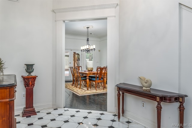 corridor with crown molding, a notable chandelier, and tile floors