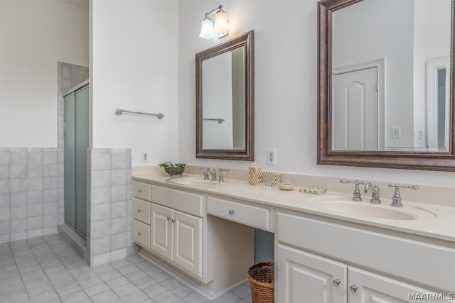 bathroom featuring tile walls, tile floors, an enclosed shower, large vanity, and double sink