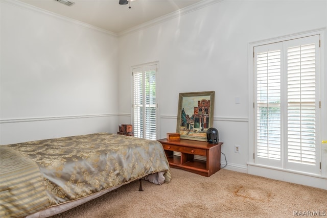 carpeted bedroom with ceiling fan and crown molding