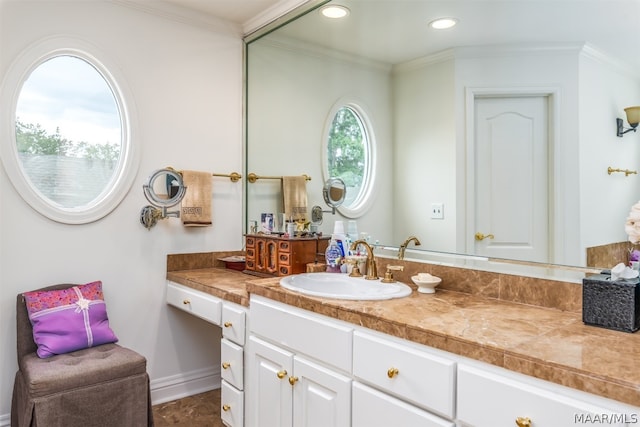 bathroom featuring crown molding and vanity