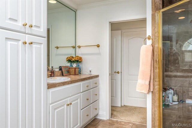 bathroom featuring tile floors, a shower with door, crown molding, and vanity