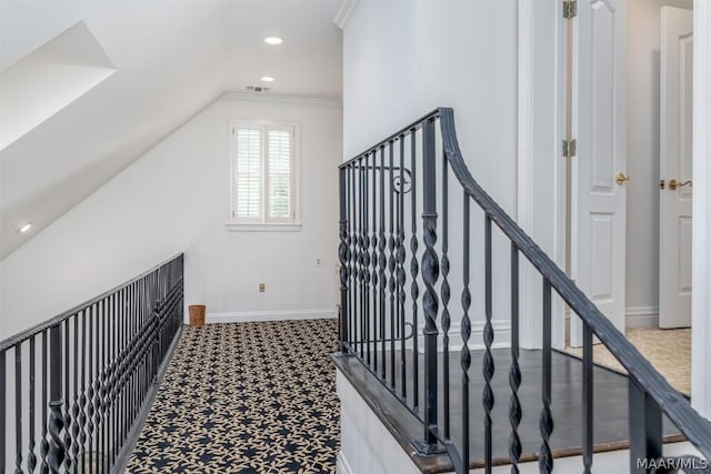 hallway with visible vents, baseboards, ornamental molding, carpet, and recessed lighting