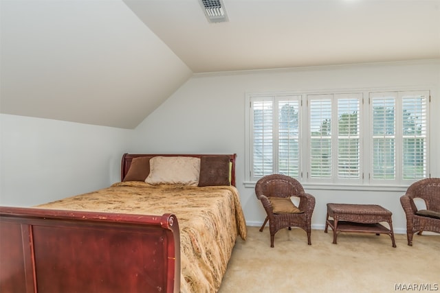 bedroom with lofted ceiling and light colored carpet