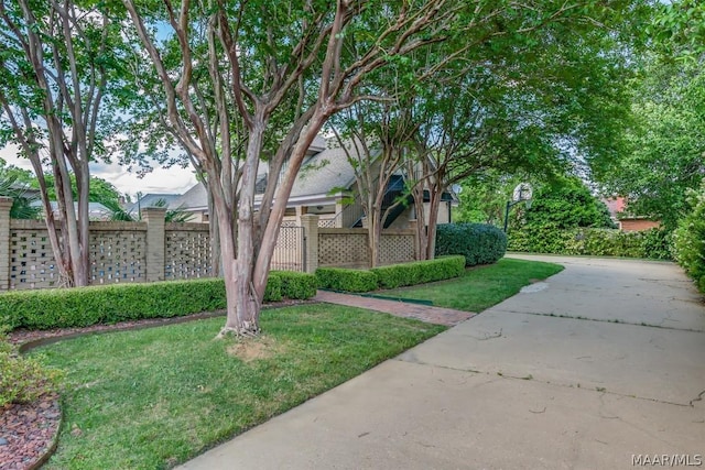 surrounding community featuring a lawn and fence