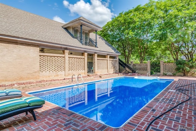 view of swimming pool with fence and a fenced in pool