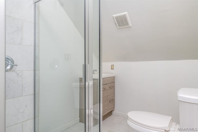 bathroom featuring tile floors, a shower with shower door, vanity, and toilet