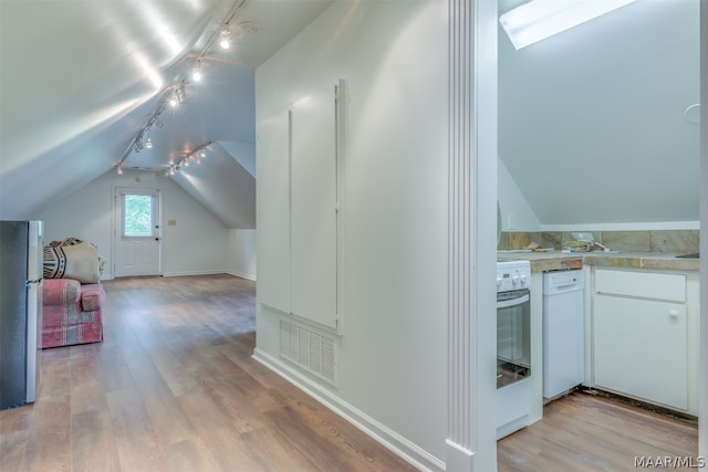 bonus room with lofted ceiling and light wood-type flooring