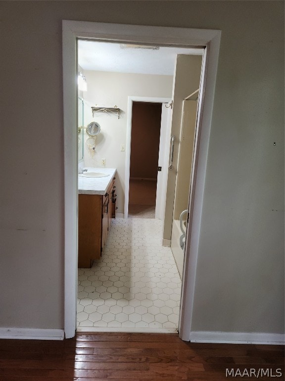 bathroom with tile flooring and vanity