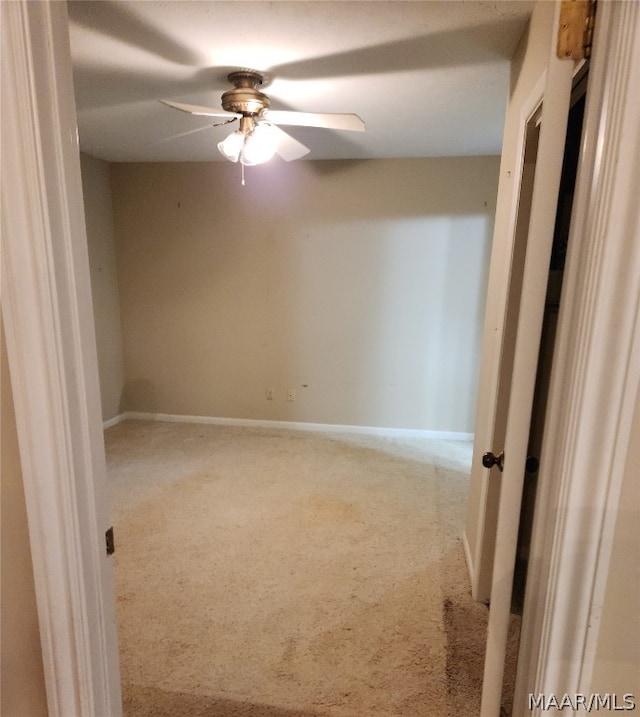 spare room with ceiling fan and carpet floors