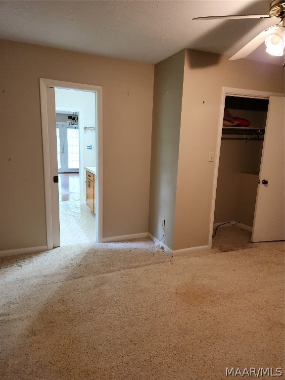 unfurnished bedroom featuring carpet flooring, a closet, and ceiling fan