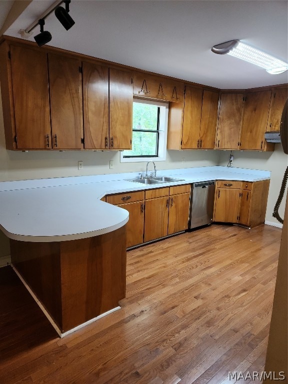 kitchen featuring sink, dishwasher, and light hardwood / wood-style flooring