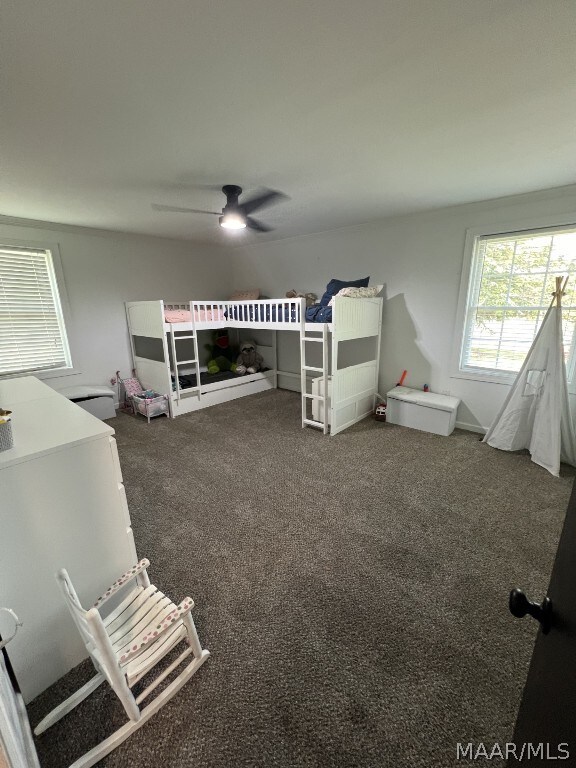 unfurnished bedroom featuring ceiling fan and carpet floors