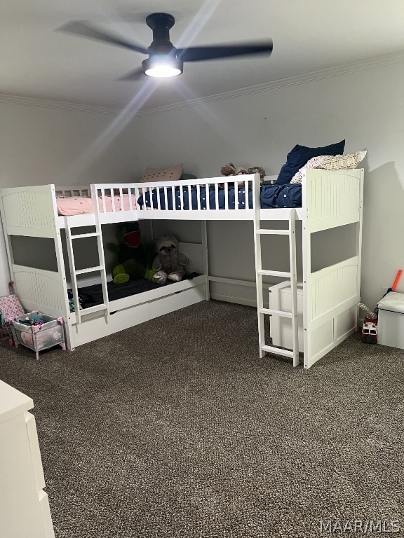 unfurnished bedroom with ornamental molding, ceiling fan, and carpet floors