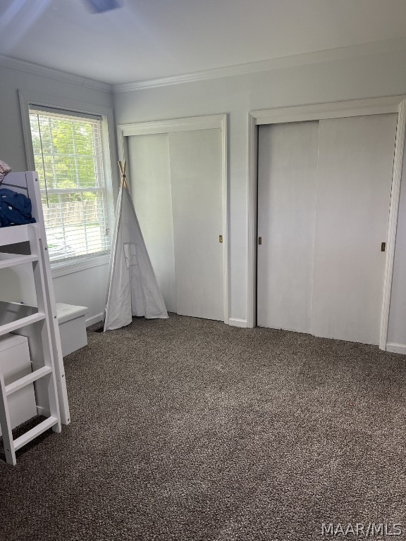 unfurnished bedroom with crown molding and carpet flooring