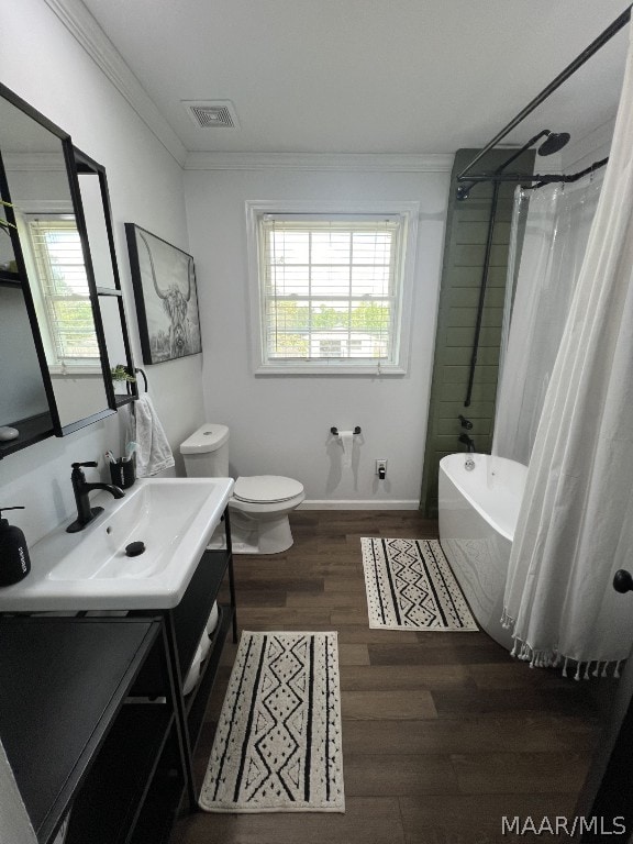 bathroom with vanity, toilet, hardwood / wood-style floors, and ornamental molding