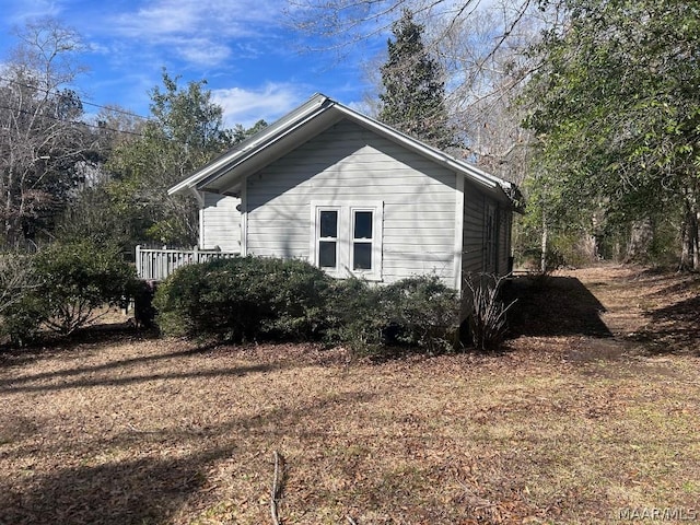 view of side of home with a lawn