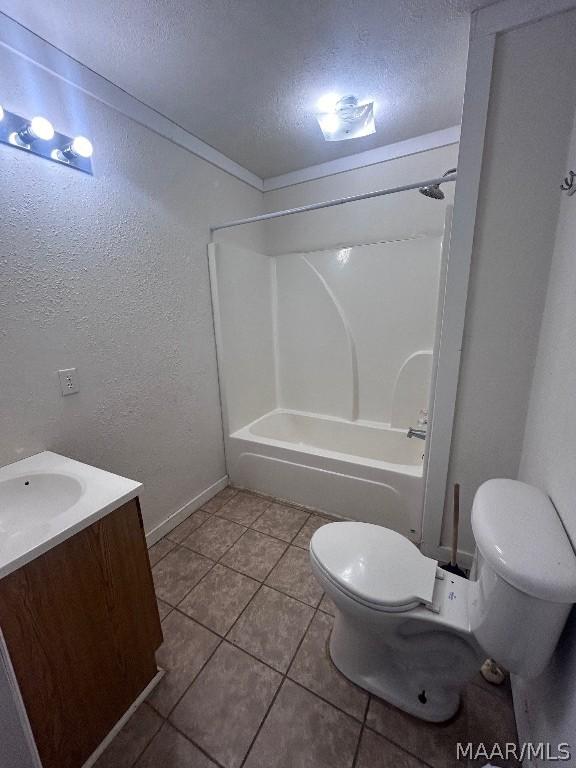 full bath with a textured wall, toilet, a textured ceiling, vanity, and washtub / shower combination