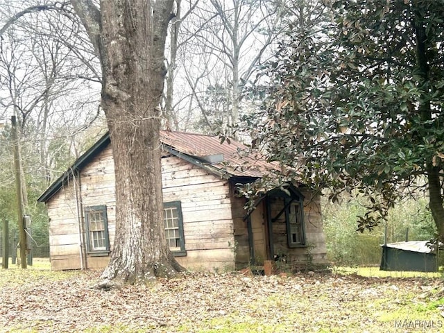 view of side of property featuring metal roof