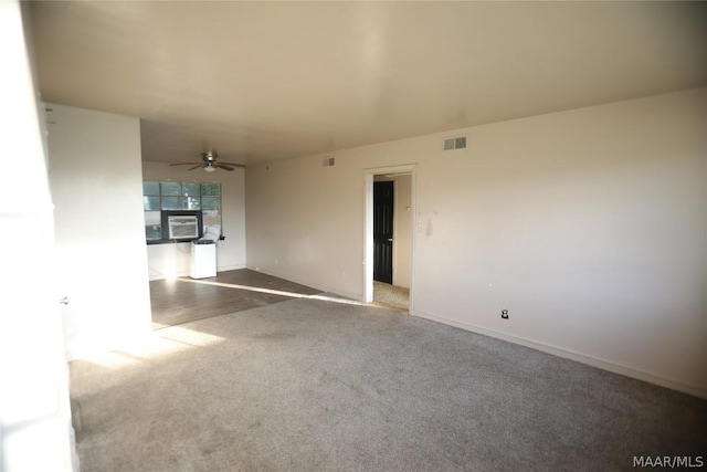 carpeted empty room featuring cooling unit and ceiling fan