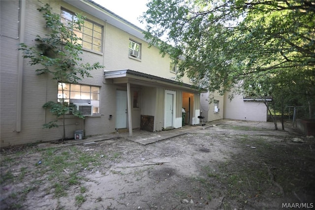 back of house featuring cooling unit